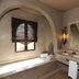 Riad Al Mendili Private Resort & Spa in Marrakech features a spa bathroom with soaking tub, sink and large mirror