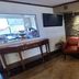 Red Roof Inn & Suites Cornelius - Lake Norman lobby seating area with stone accent wall and lamp
