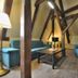Castle Residence Krumlov lounge with blue sofas, coffee table and exposed timber beams in Český Krumlov