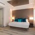 Marketplace Suites in St. John guest room with king bed, desk, and warm modern lighting
