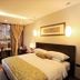 Demen Renli Hotel in Chengdu guest room with king bed, warm lighting, and window seating