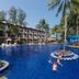 Sunwing Bangtao Beach in Choeng Thale with a large blue resort pool, palm trees, and guests swimming