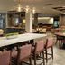 Inn at Bellefield / Hyde Park lobby lounge with long communal table, pendant lights and seating