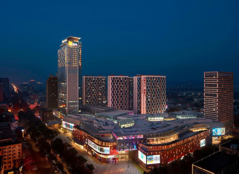 Sheraton Zibo Hotel in Zibo at night, with illuminated high-rise tower and cityscape views