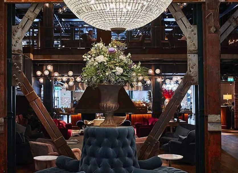 The Steam Hotel, Västerås: grand lobby with chandelier, floral centerpiece and lounge seating