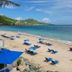 Divi Carina Bay Beach Resort & Casino in Christiansted: sandy beach with blue lounge chairs and turquoise water