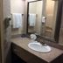 Triplodge of Santa Clarita bathroom vanity with sink, mirror, towels and wall-mounted hair dryer