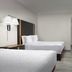 Hampton Inn & Suites El Paso-East guest room with two beds, TV, and light wood flooring