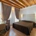 Unahotels Eco Hotel Villa Costanza Venezia in Venice, room with wood-beam ceiling and draped windows