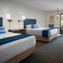 Ashland Hills Hotel & Suites in Ashland: guest room with two beds, desk, and balcony view