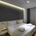 Workinn Hotel, Gebze: modern guest room with double bed, bedside table, chair, and floor-to-ceiling curtains