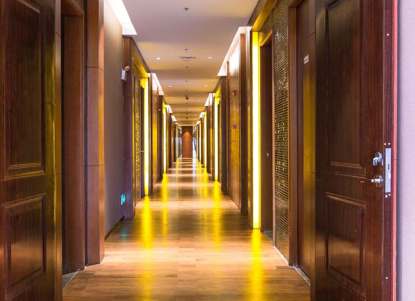 Landmark Mekong Riverside Hotel in Vientiane hallway with warm lighting and wood-paneled doors
