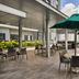 Oakwood Residence Saigon rooftop terrace in Ho Chi Minh City with tables, chairs and city views