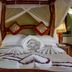 Mbuzi Mawe Serena Camp in Serengeti, canopy bed with mosquito net and folded towel swan on the bed