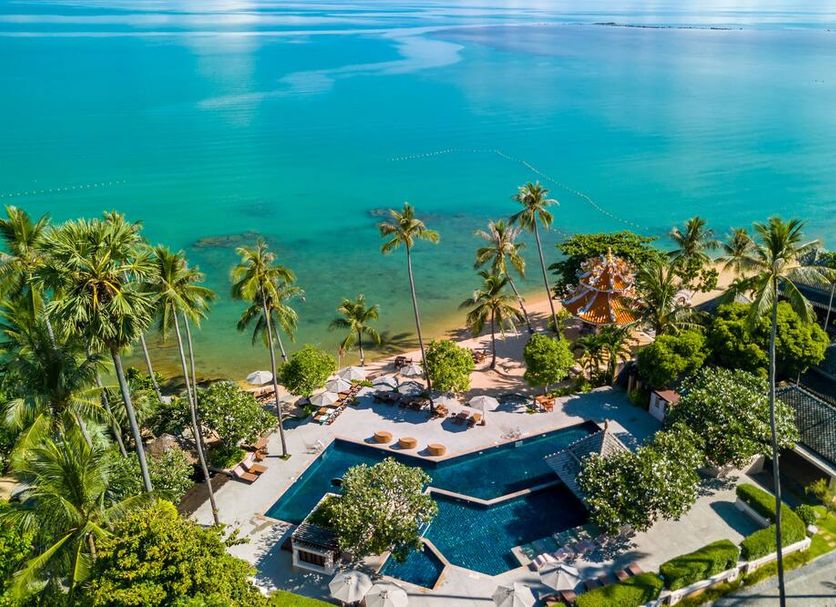 Fair House Villas & Spa, Koh Samui: beachfront pool surrounded by palm trees overlooking turquoise sea