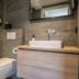 Landgoed De Uitkijk Hellendoorn bathroom with glass shower, wall-hung toilet and sink vanity