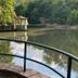 Waldhotel Silbermühle in Horn-Bad Meinberg by a tranquil lakeside with a covered dock and railing