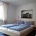 Pension Sonnalp room in Ortisei with twin beds, checkered bedding, and motorcycle wall art