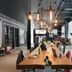 Moxy Milton Keynes lobby with long communal table, modern pendant lights and seating area