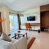 Phavina Hotel & Grand Boutique Rayong suite with sofa, desk, TV, and balcony view in Rayong