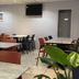 Hotel Inn Design Le Havre in Montivilliers dining area with tables, chairs and wall-mounted TV