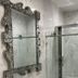 Retreat At Crystal Manatee in Crystal River bathroom with marble walls, glass shower and ornate mirror