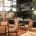 ibis Abu Dhabi Gate lounge with bar seating and green tiled counter in Abu Dhabi