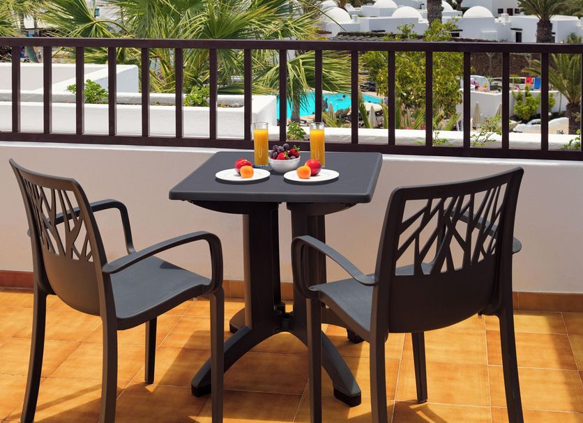 H10 Suites Lanzarote Gardens in Costa Teguise balcony dining table with pool and palm views