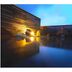 Minshuku Unagi Kohan in Ibusuki features a serene outdoor hot spring pool at dusk.