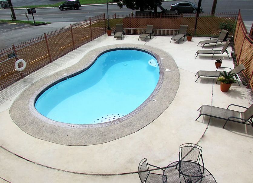 Express Inn & Suites San Antonio Near Sea World Medical Center pool with loungers and patio