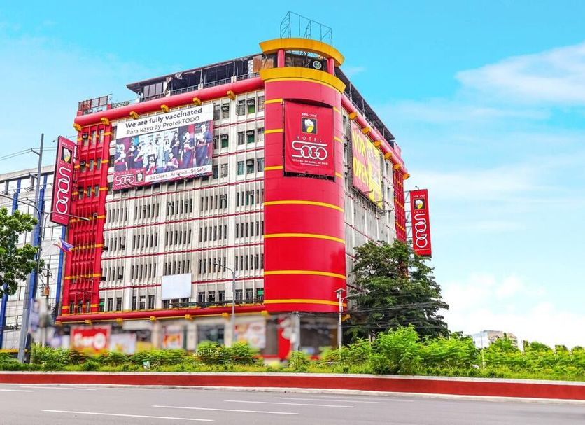 Hotel Sogo Quezon Avenue in Manila, red-and-white hotel exterior with roadside landscaping