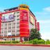 Hotel Sogo Quezon Avenue in Manila, red-and-white hotel exterior with roadside landscaping