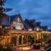The Torrance Hotel in Glasgow with a warmly lit entrance and string lights at dusk