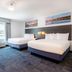 Independence Stay Hotel and Long term suites in Houghton guest room with two beds and window view
