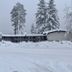 The Inn at Boatworks, Lake Tahoe in Tahoe City, snow-covered lodge among tall pine trees