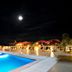 Night view of Wyndham Costa del Sol Pucallpa in Pucallpa with a lit outdoor pool and lounge area