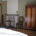 La Maison De Maitre in Arbrefontaine: guest room with sink, fireplace, chair and wooden armoire