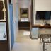 The House of Water in Dongshan Township room with wall TV, vanity, minibar and ornate decor