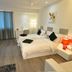 Hotel Vijay Parkinn, Coimbatore room with two twin beds, wall-mounted TV, and window curtains