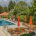 Hotel Aquarius Dubrovnik pool terrace with loungers and orange umbrellas in Dubrovnik