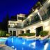 Chalay Monta Hua Hin hotel pool at night with lit swimming pool, lounge chairs, and balconies