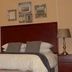 Oak Rest Guesthouse in Kimberley: guest room with bed, lamps, framed wall art and decorative vase.