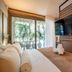 Duke Beach Hotel Maresias room with king bed, TV and sliding glass doors to a private patio
