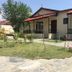Katero in Pokhara: single-story hotel cottages with red awnings beside a landscaped garden path