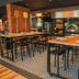 ibis Santiago Las Condes restaurant interior with communal tables, bar seating, and pizza oven