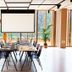 Hotel Arima & Spa meeting room in San Sebastian with long conference table, projector screen, and floor-to-ceiling windows