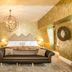 The Shankly Hotel Liverpool suite with ornate gold decor, chandelier, leather sofa and king bed