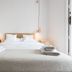 Bruc & Bruc, Barcelona: minimalist bedroom with double bed, pendant lights, and folded towels