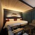 Richmond Hotel Yokohama-Bashamichi room with twin beds, sofa, and dark curtains in Yokohama