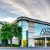 Holiday Inn Express & Suites Chicago O'hare Airport By IHG in Des Plaines, exterior with glass entrance and trees